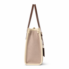 A structured tote bag with a dusty pink canvas body, cream-colored trim, and dark brown leather shoulder straps, shown from a side profile view on a white background.