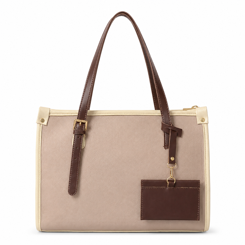A structured tote bag with a beige canvas body, dark brown faux-leather handles and accents, and gold-tone hardware, shown on a plain white background.