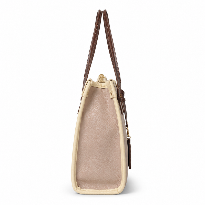 A structured tote bag shown from the side, featuring a light beige canvas body, cream leather trim, and dark brown shoulder straps, photographed against a solid white background.